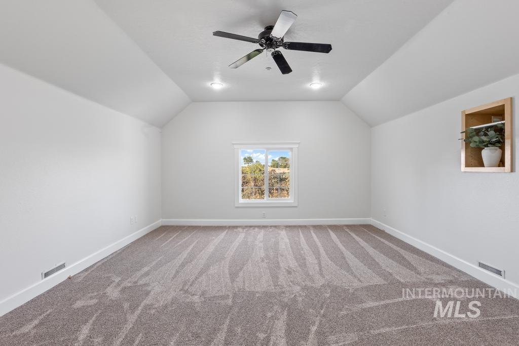 28279 Pearl Road Parma, ID 83660 - Photo 42 of 46 Bonus room featuring light colored carpet, vaulted ceiling, and ceiling fan