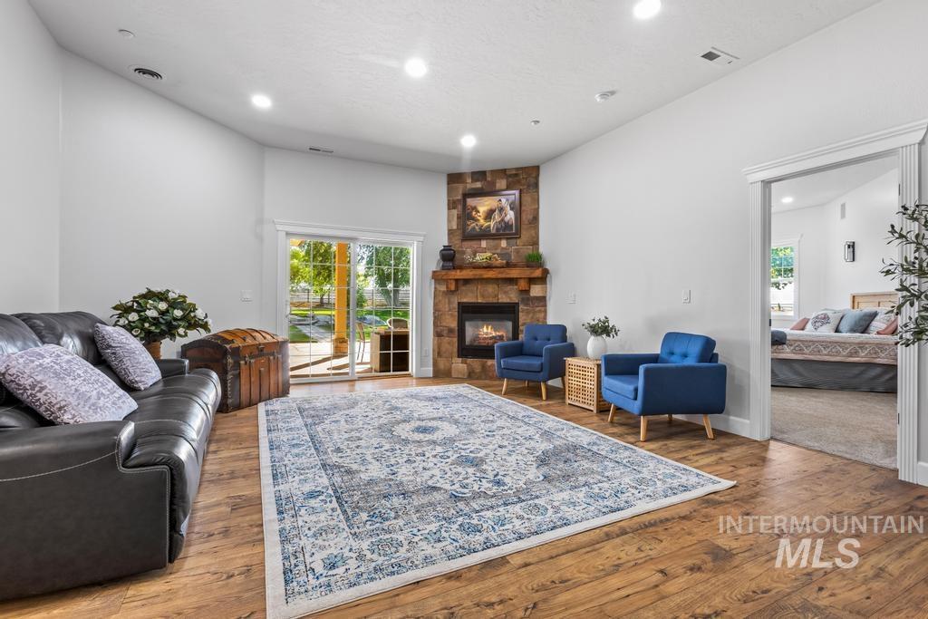 28279 Pearl Road Parma, ID 83660 - Photo 5 of 46 Living room with recessed lighting, plenty of natural light, wood finished floors, and a fireplace