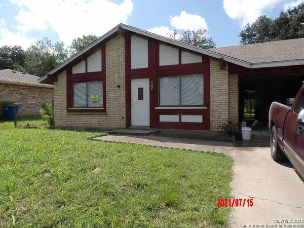 a view of a house with yard and sitting area