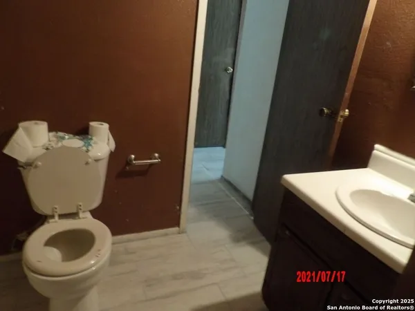 a bathroom with a toilet sink and mirror