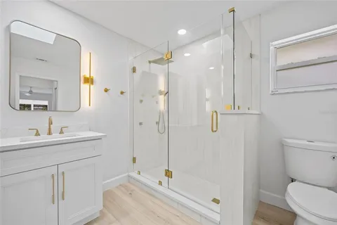 a spacious bathroom with a double vanity sink a mirror a shower and a bathtub