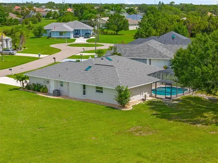 an aerial view of a house with a swimming pool yard and outdoor seating