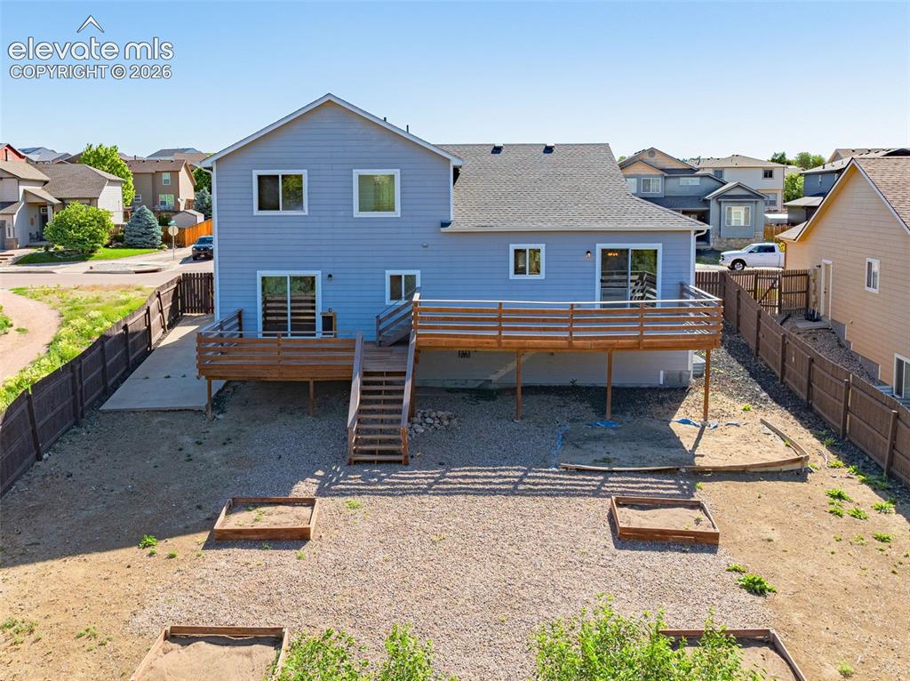 11185 Falling Star Road Fountain, CO 80817 - Photo 35 of 46 a backyard of a house with barbeque oven table and chairs
