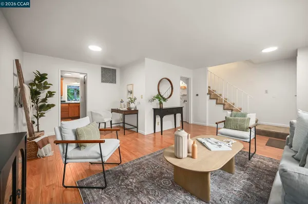 a living room with fireplace furniture and a wooden floor