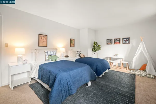 a bedroom with two beds and a couch