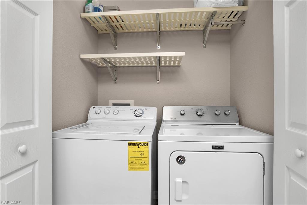 9719 Acqua Court, Unit 214 Naples, FL 34113 - Photo 24 of 50 a utility room with dryer and washer