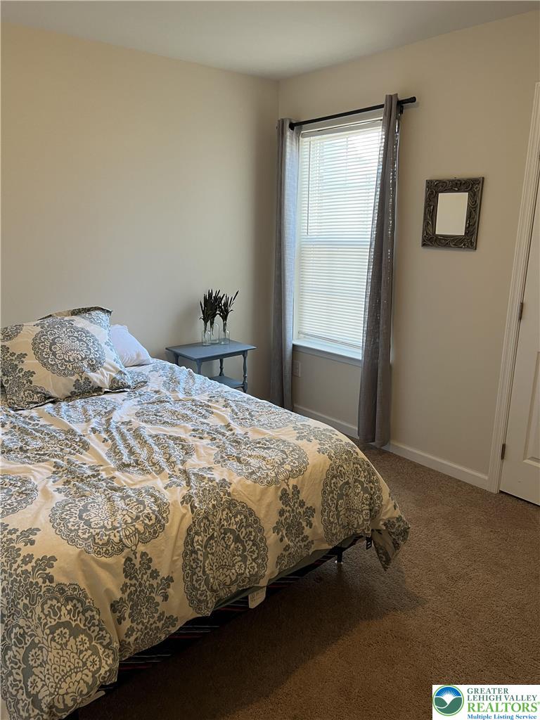5380 Jutland Road Allentown, PA 18104 - Photo 12 of 27 A well-lit bedroom features plush carpeting and a large window providing ample natural light.