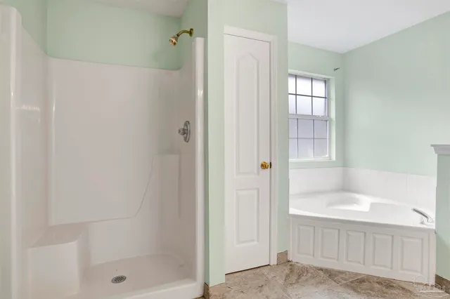 a bathroom with a tub and shower