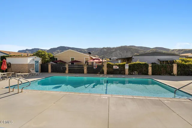 a view of house with a yard and street