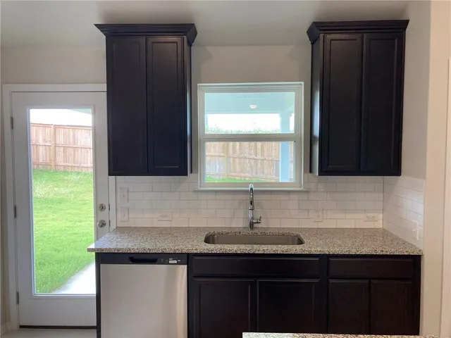 a kitchen with a sink and a window