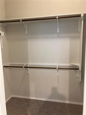 a white toilet sitting next to a white cabinet