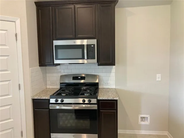 a kitchen with a stove and a microwave