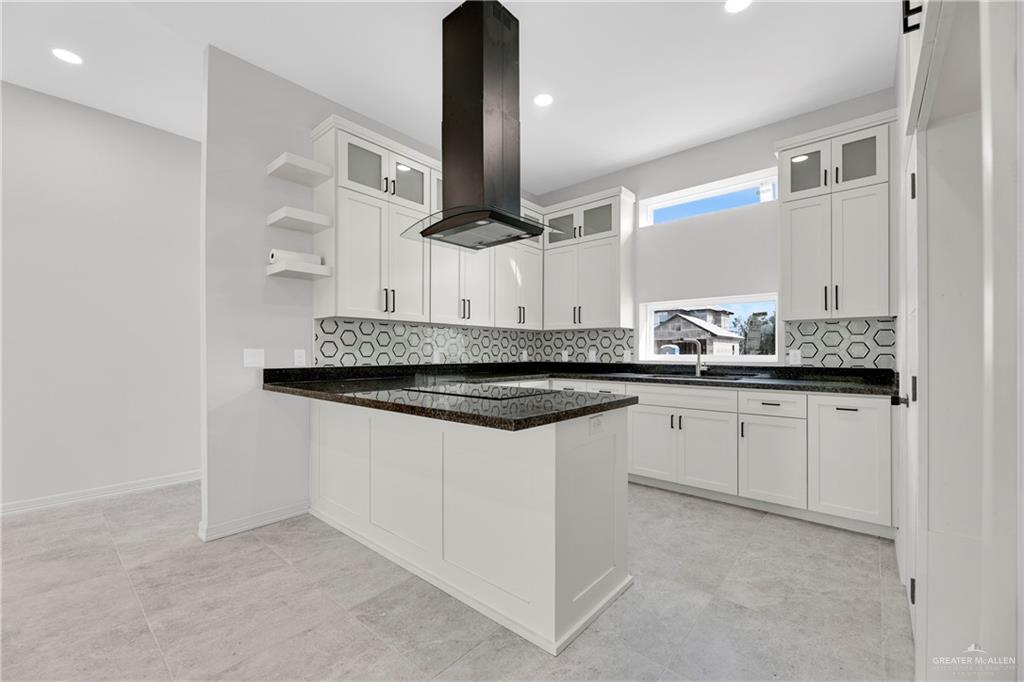 425 South 12th Street Alamo, TX 78516 - Photo 2 of 15 a kitchen with stainless steel appliances granite countertop a sink and a white cabinets