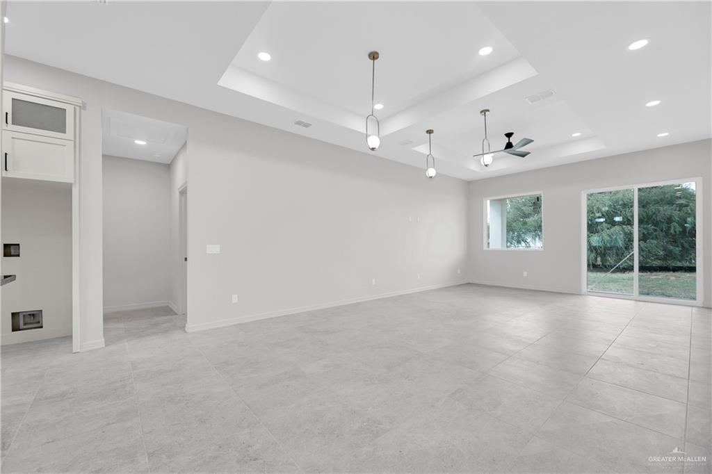 425 South 12th Street Alamo, TX 78516 - Photo 5 of 15 an empty room with windows and ceiling fan