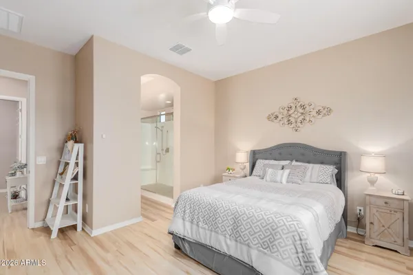 a bedroom with a large bed and a chandelier
