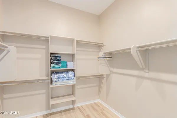a view of walk in closet with empty racks