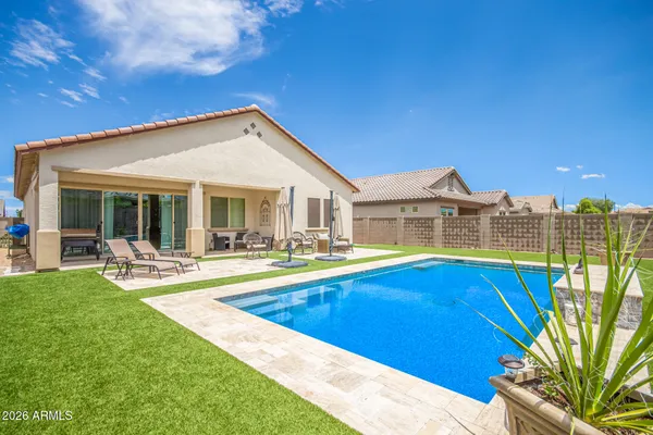 a view of a house with swimming pool and porch