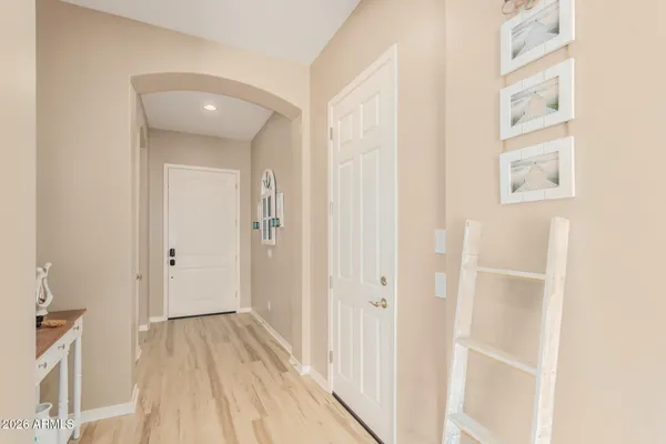 a view of a hallway with wooden floor and entryway