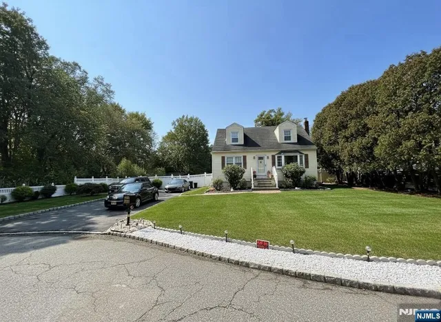 a front view of a house with a garden and pathway