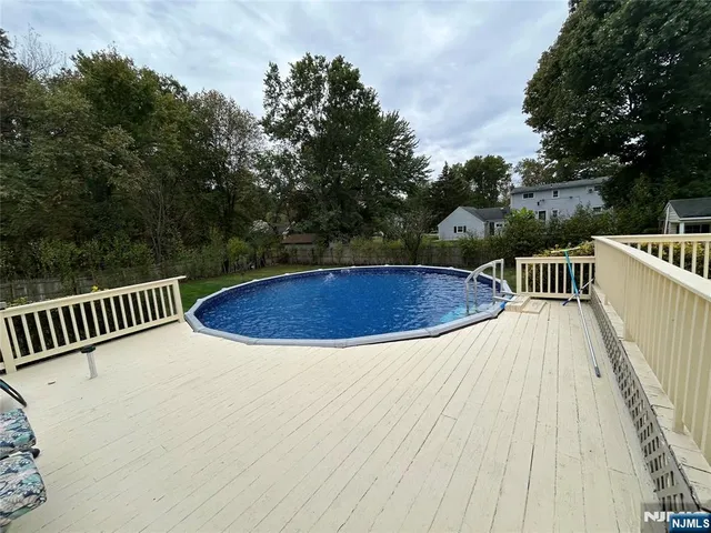a view of balcony with wooden floor and outdoor seating