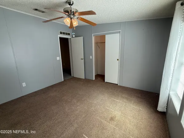 a view of a storage and utility room with refrigerator