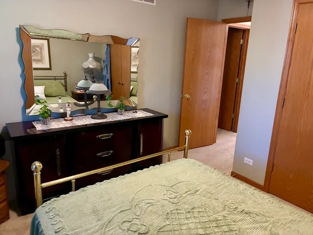 a bedroom with a bed and a mirror