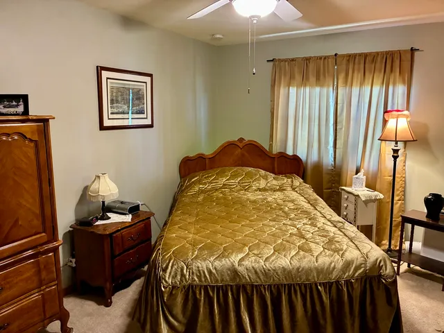 a bed sitting in a room next to a window