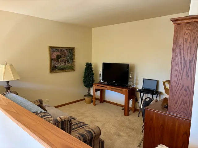 a bedroom with furniture and a flat screen tv