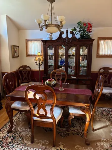 a living room with furniture a chandelier and a window