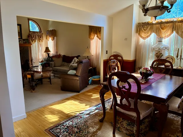 a living room with furniture a window and a chandelier