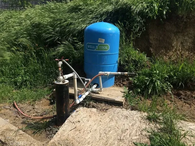 a roof deck with table and chairs and potted plants
