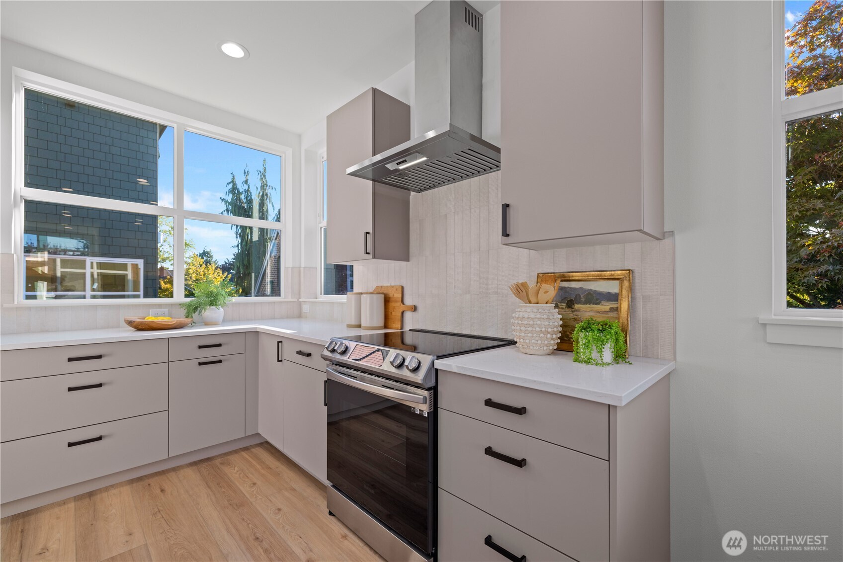 1704 North 47th Street Seattle, WA 98103 - Photo 11 of 38 a kitchen with stainless steel appliances white cabinets and a sink