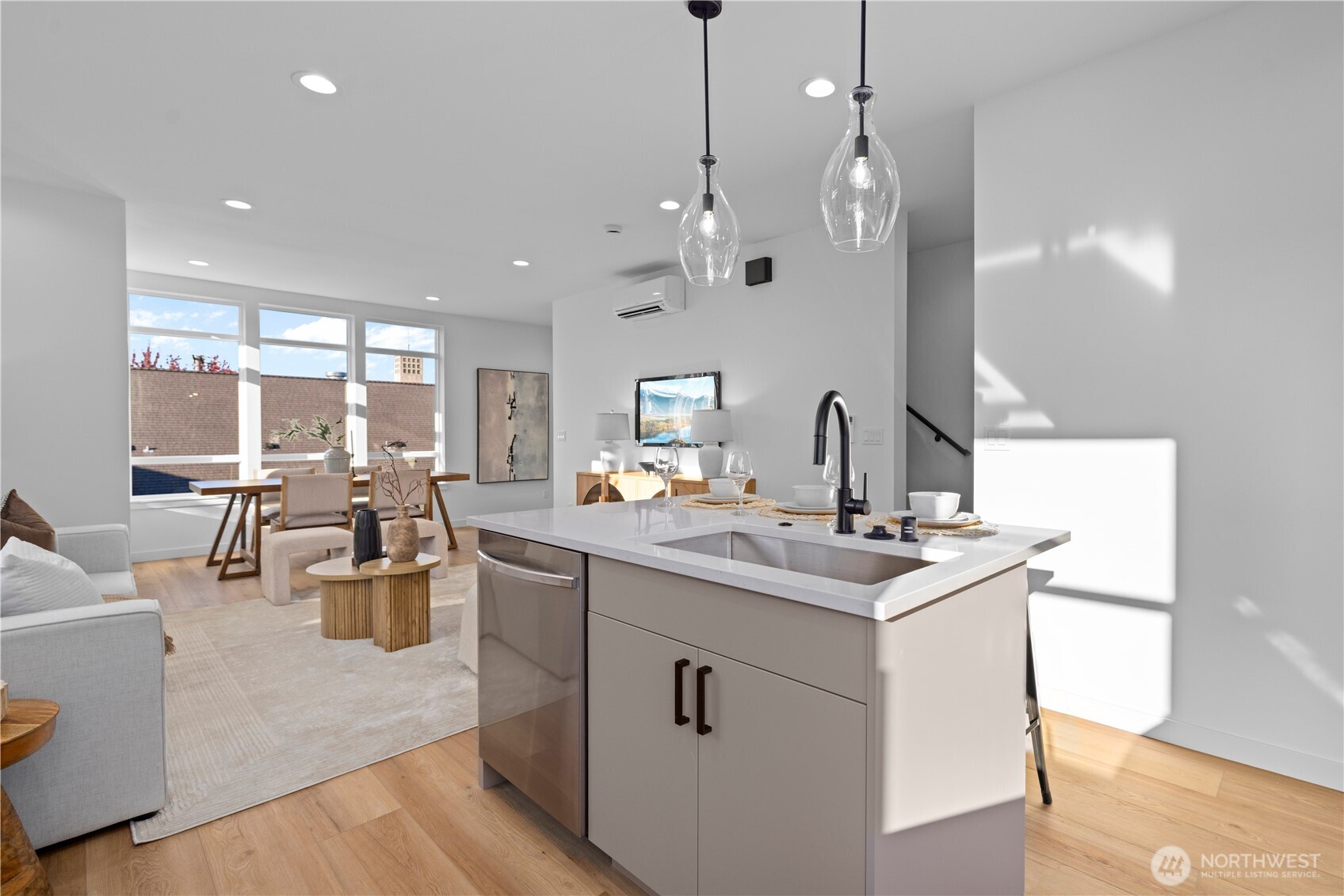1704 North 47th Street Seattle, WA 98103 - Photo 12 of 38 a kitchen with counter top space sink and living room view