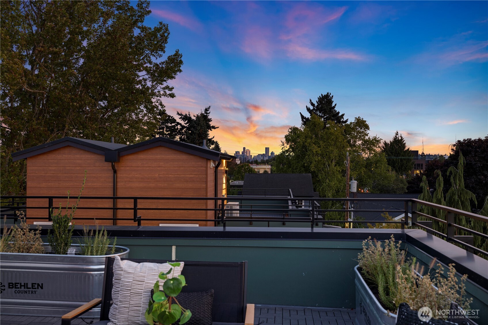1704 North 47th Street Seattle, WA 98103 - Photo 33 of 38 a view of a roof deck with couches and sky view