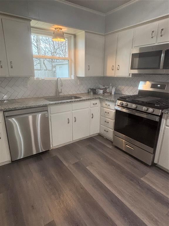 116 South 10th Street Sanger, TX 76266 - Photo 2 of 7 a kitchen with granite countertop a stove a sink and a microwave