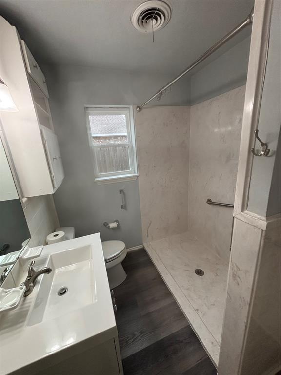 116 South 10th Street Sanger, TX 76266 - Photo 7 of 7 a bathroom with a sink a mirror and a shower