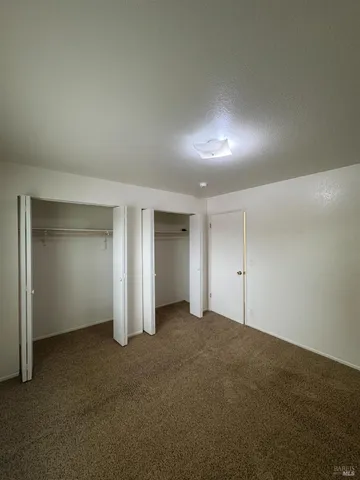 an empty room with closet area and closet