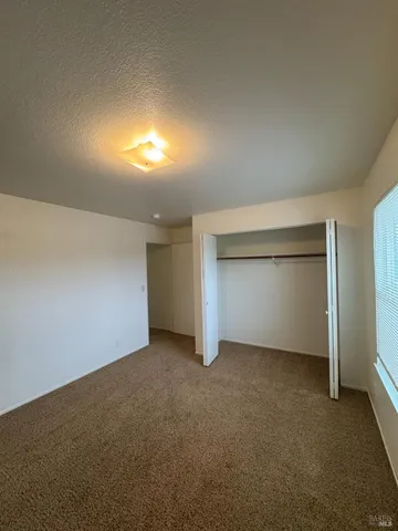 an empty room with a empty space and windows