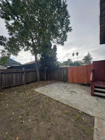 a backyard of a house with a tree