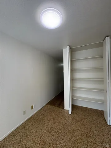 a view of an empty room with a fireplace