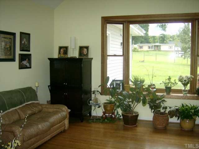 375 Chambers Loop Road Timberlake, NC 27583 - Photo 3 of 12 OPEN LIVING ROOM OFFERS CATHEDRAL CEILING AND A VIEW OF THE FRONT AND BACK YARDS