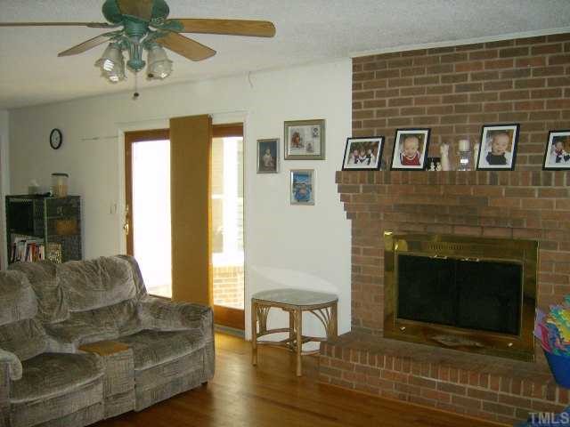 375 Chambers Loop Road Timberlake, NC 27583 - Photo 8 of 12 SPACIOUS FAMILY ROOM HAS FIREPLACE, SHELVING AND WOOD FLOORING