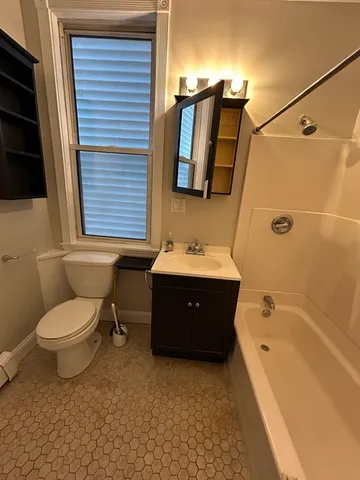 a spacious bathroom with a bathtub sink and toilet