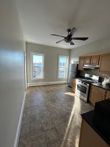 a kitchen with stainless steel appliances granite countertop a stove a sink and a refrigerator