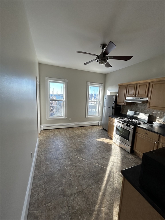 279 Webster Street, Unit 2 Boston, MA 02128 - Photo 13 of 20 a kitchen with stainless steel appliances granite countertop a stove a sink and a refrigerator