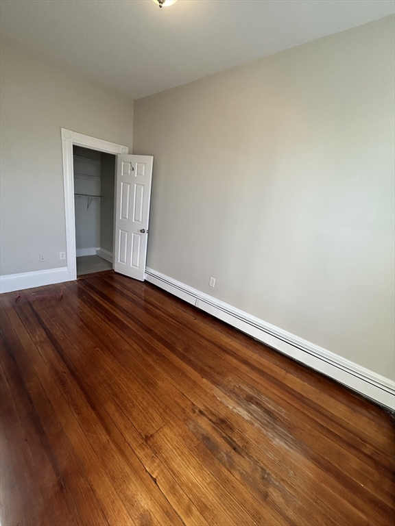 279 Webster Street, Unit 2 Boston, MA 02128 - Photo 16 of 20 a view of an empty room with wooden floor