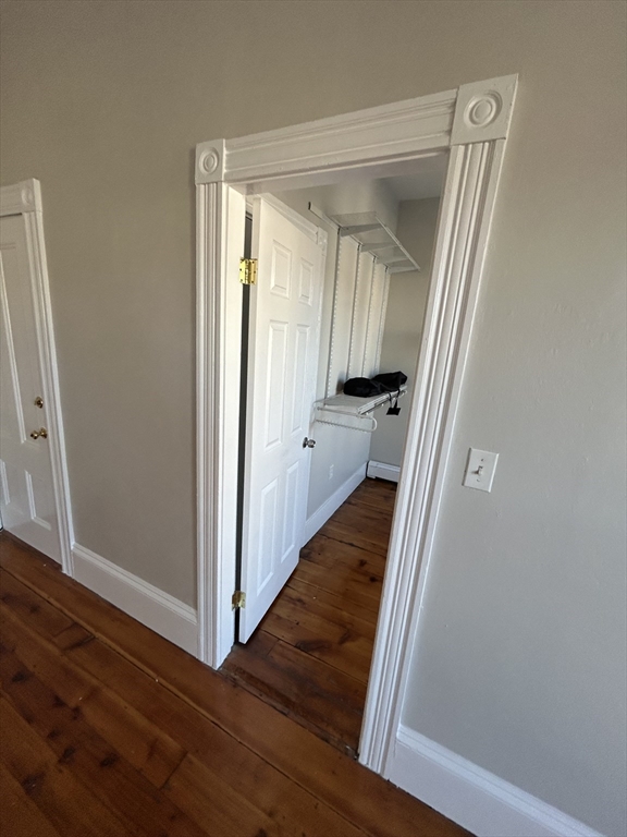 279 Webster Street, Unit 2 Boston, MA 02128 - Photo 6 of 20 a view of a hallway with wooden floor and staircase