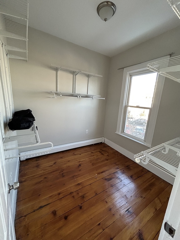 279 Webster Street, Unit 2 Boston, MA 02128 - Photo 7 of 20 a view of empty room with wooden floor and fan