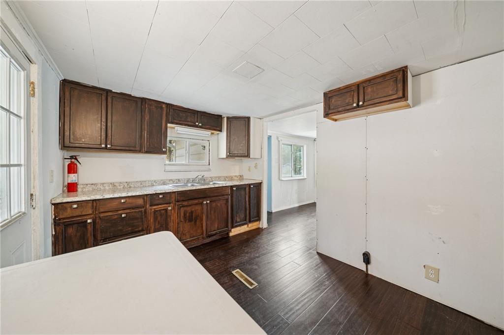 119 Story Road Export, PA 15632 - Photo 11 of 38 a kitchen with stainless steel appliances granite countertop a refrigerator a stove top oven a sink dishwasher and wooden floor