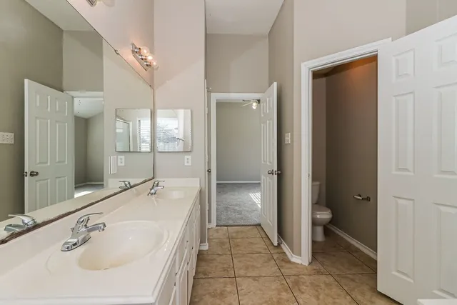 a bathroom with a tub sink and mirror